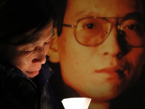 Eine Aktivistin weint neben einem Plakat, das den inhaftierten Liu Xiaobo zeigt