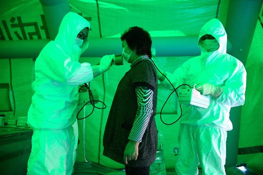 Eine Anwohnerin von Fukushima wird auf Strahlen untersucht