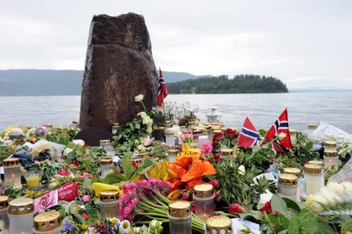 Blumen und Kerzen auf der Küstenlinie gegenüber der Insel Utøya