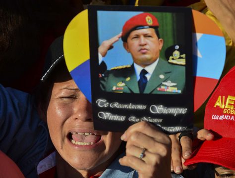 Vor der Militärakademie Fuerte Tiuna halten Trauernde Bilder von Chávez in die Höhe