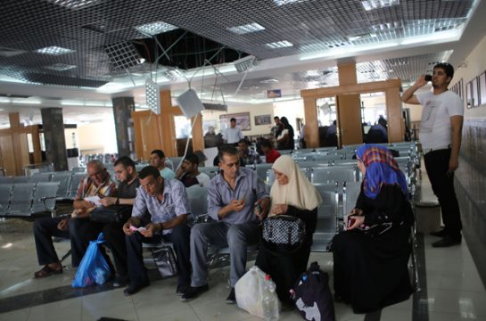 Palästinenser warten in einer zerstörten Eingangshalle am Rafah-Grenzübergang auf eine Einreise nach Ägypten