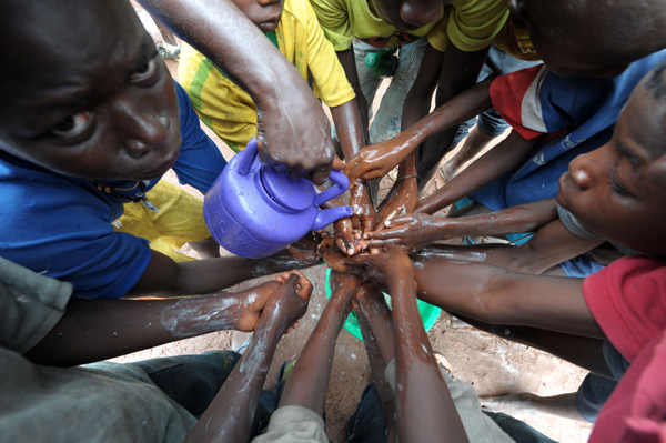 Markt in Diaobe/Senegal: Menschen waschen ihre Hände mit Wasser und Bleichmittel, um eine Ausbreitung von Ebola zu verhindern