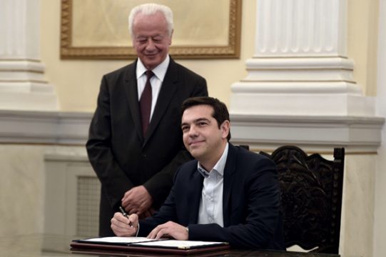 Alexis Tsipras unterschreibt ein Buch bei seiner Eidesablegung als neuer Ministerpräsident Griechenlands