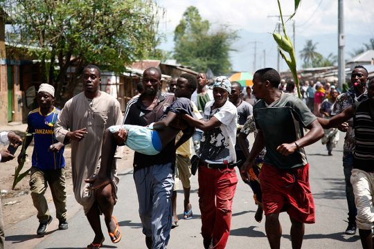 Demonstranten in der burundischen Hauptstadt Bujumbura tragen einen bei einer Auseinandersetzung mit der Polizei getöteten Mann