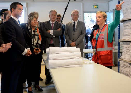 Manuel Valls (l.) in einem Empfangszentrum für Flüchtlinge in Calais