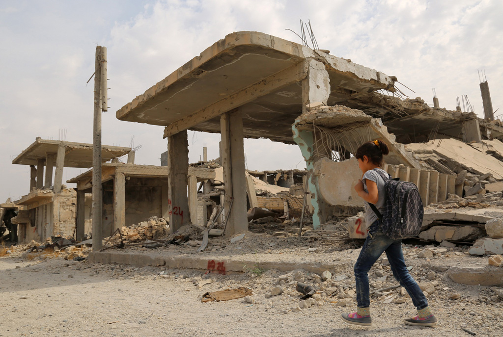 Syrisches Kind neben zerstörten Gebäuden in Kobane (6.10.)