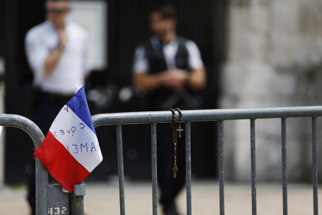 Rosenkranz und Nationalflagge vor der Kirche Saint-Etienne-du-Rouvray, in der der Priester am 26. Juli umgebracht wurde