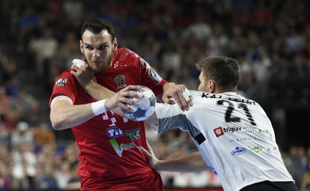 Veszprem's Borut Mackovsek and Vardar's Glab Kalarash (R) vie during the EHF Champions League final handball match between HC Vardar and Telekom Veszprem in Cologne, western Germany, on June 2, 2019. (Photo by INA FASSBENDER / AFP)