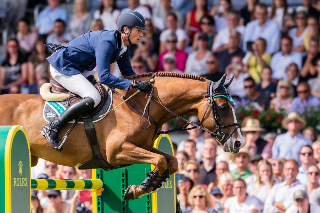 21 July 2019, North Rhine-Westphalia, Aachen: CHIO, equestrian sport, jumping, Grand Prix of Aachen: The rider Daniel Deußer from Germany on the horse Scuderia jumps over an obstacle. Photo: Rolf Vennenbernd/dpa