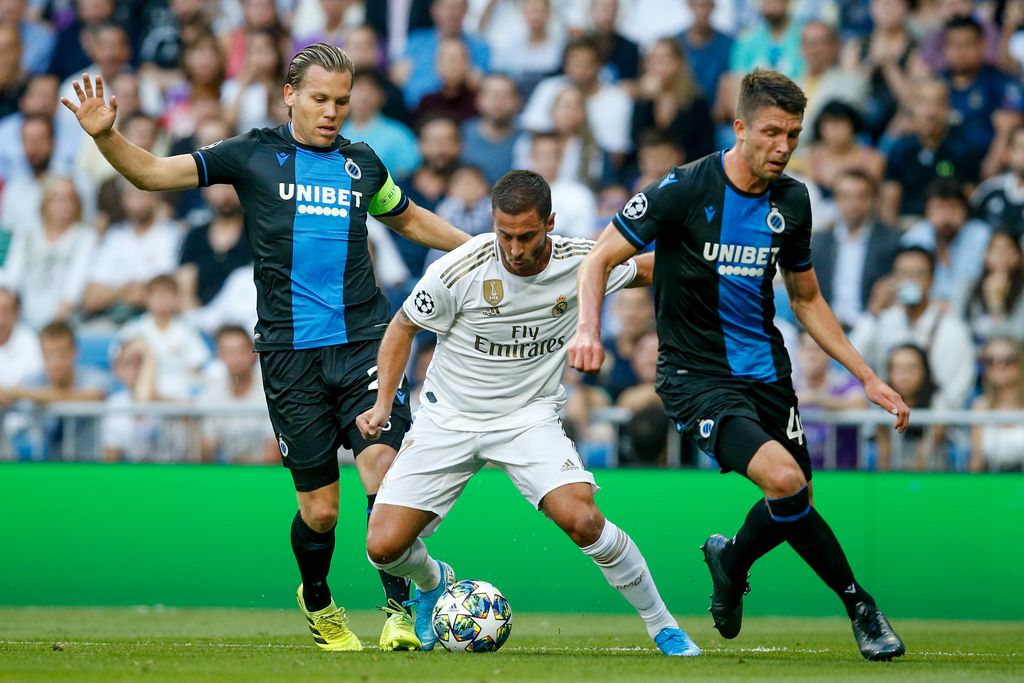Club's Ruud Vormer, Real's Eden Hazard and Club's Brandon Mechele fight for the ball during a game between Belgian soccer team Club Brugge and Spanish club Real Madrid on the second day (out of 6) in the group stage of the UEFA Champions League , Tuesday 01 October 2019 in Madrid, Spain. BELGA PHOTO BRUNO FAHY