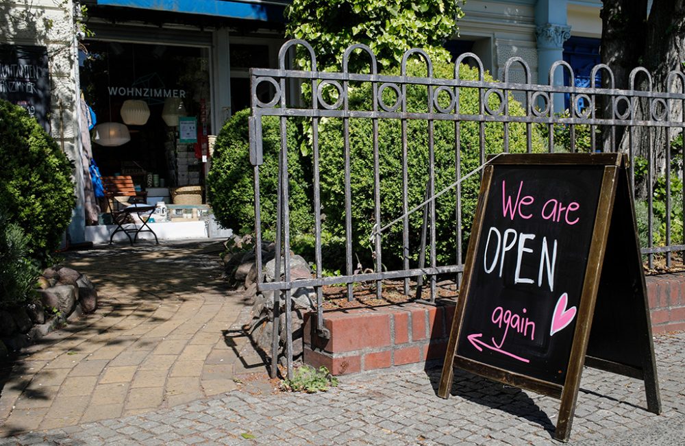 A sign outside a shop announces its re-opening in Berlin's Kreuzberg district on April 22, 2020, amid the novel coronavirus COVID-19 pandemic. - In Germany, which been among the most successful in Europe to contain the disease and where authorities have declared it "under control", smaller shops in some regions were to re-open on April 20, 2020. (Photo by David GANNON / AFP)