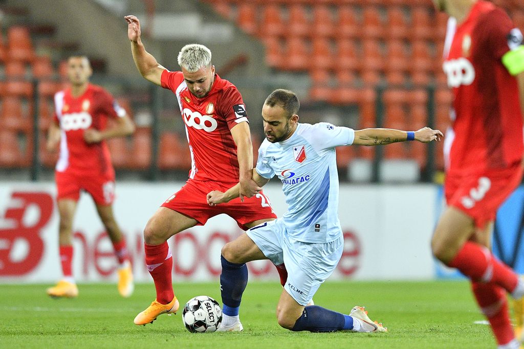 Standard's Nicolas Raskin and Vojvodina's Nemanja Covic fight for the ball during a soccer match between Belgian Standard de Liege and Serbian soccer club FK Vojvodina, Thursday 24 September 2020 in Liege, in the third qualifying round for the UEFA Europa League. BELGA PHOTO YORICK JANSENS
