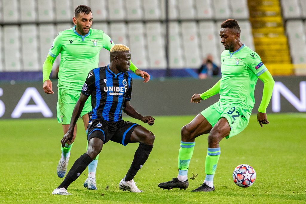 Club's Krepin Diatta and Lazio's Jean-Daniel Akpa-Akpro fight for the ball during the second group stage game of the UEFA Champions League, in the group F, between Belgian soccer team Club Brugge and Italian club SS Lazio Roma, Wednesday 28 October 2020 in Brugge. BELGA PHOTO KURT DESPLENTER