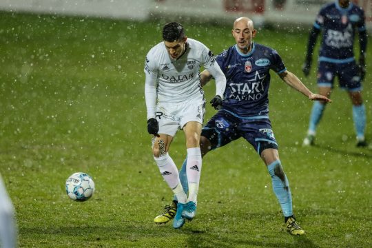 Eupen's Stef Peeters and Mouscron's Christophe Lepoint fight for the ball during a soccer match between KAS Eupen and Royal Excel Mouscron, Saturday 30 January 2021 in Eupen, on day 23 of the 'Jupiler Pro League' first division of the Belgian championship. BELGA PHOTO BRUNO FAHY