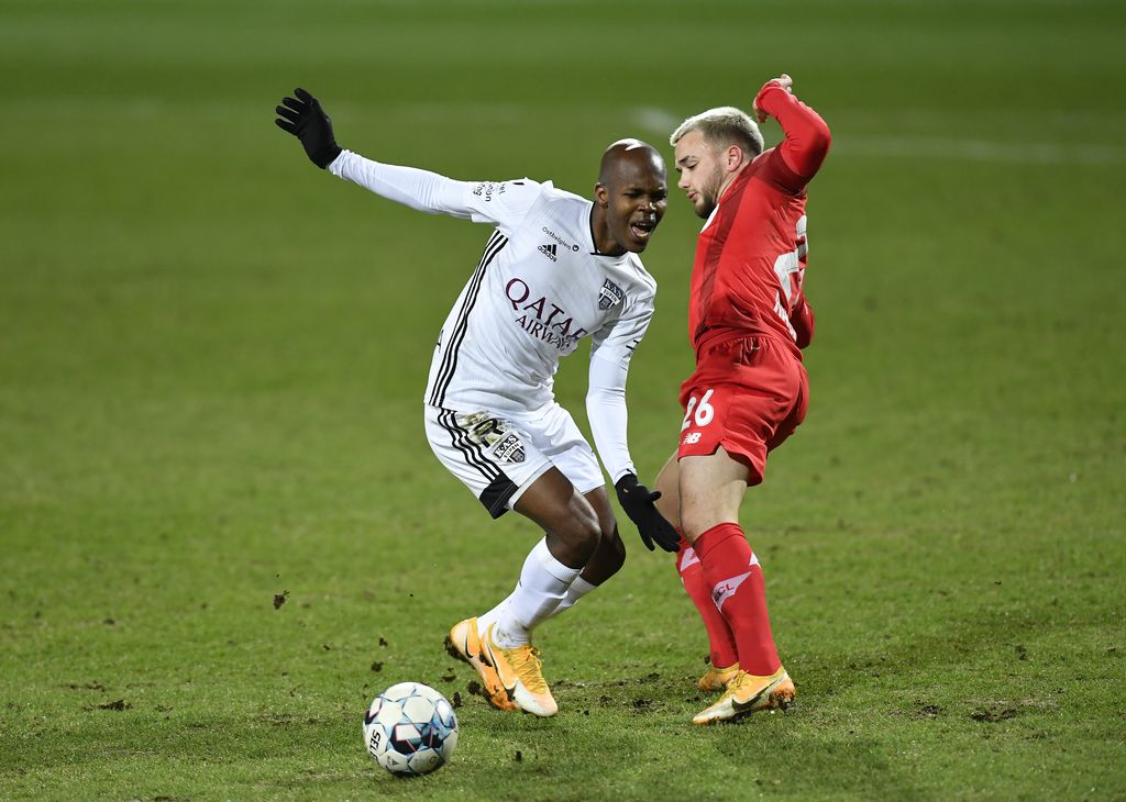 Eupen's Knowledge Musona and Standard's Nicolas Raskin fight for the ball during a soccer game between KAS Eupen and Standard de Liege, Saturday 13 March 2021 in Eupen, in the semifinals of the 'Croky Cup' Belgian cup. BELGA PHOTO JOHN THYS
