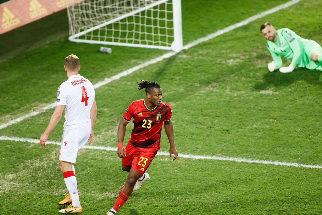 Belgium's Michy Batshuayi celebrates after scoring the 1-0 goal and Belarus' goalkeeper Aleksandr Gutor is down at a qualification game for the World Cup 2022 in the group E between the Belgian national team Red Devils and Belarus (third out of eight games), Tuesday 30 March 2021 in Leuven. BELGA PHOTO BRUNO FAHY