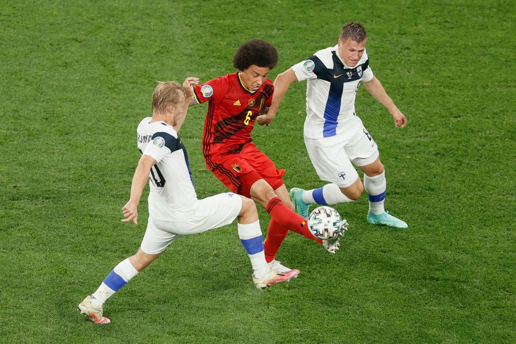 Finnish Joel Pohjanpalo, Belgium's Axel Witsel and Finnish Robin Lod fight for the ball during a soccer game between Finland and Belgium's Red Devils, the third game in the group stage (group B) of the 2020 UEFA European Football Championship, on Monday 21 June 2021 in Saint Petersburg, Russia. BELGA PHOTO BRUNO FAHY