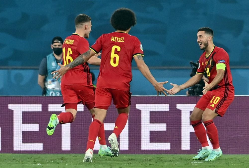 Belgium's Thorgan Hazard, Belgium's Axel Witsel and Belgium's Eden Hazard celebrate after scoring the 1-0 goal during the round of 16 game of the Euro 2020 European Championship between the Belgian national soccer team Red Devils and Portugal, in Sevilla, Spain, Sunday 27 June 2021. BELGA PHOTO LAURIE DIEFFEMBACQ