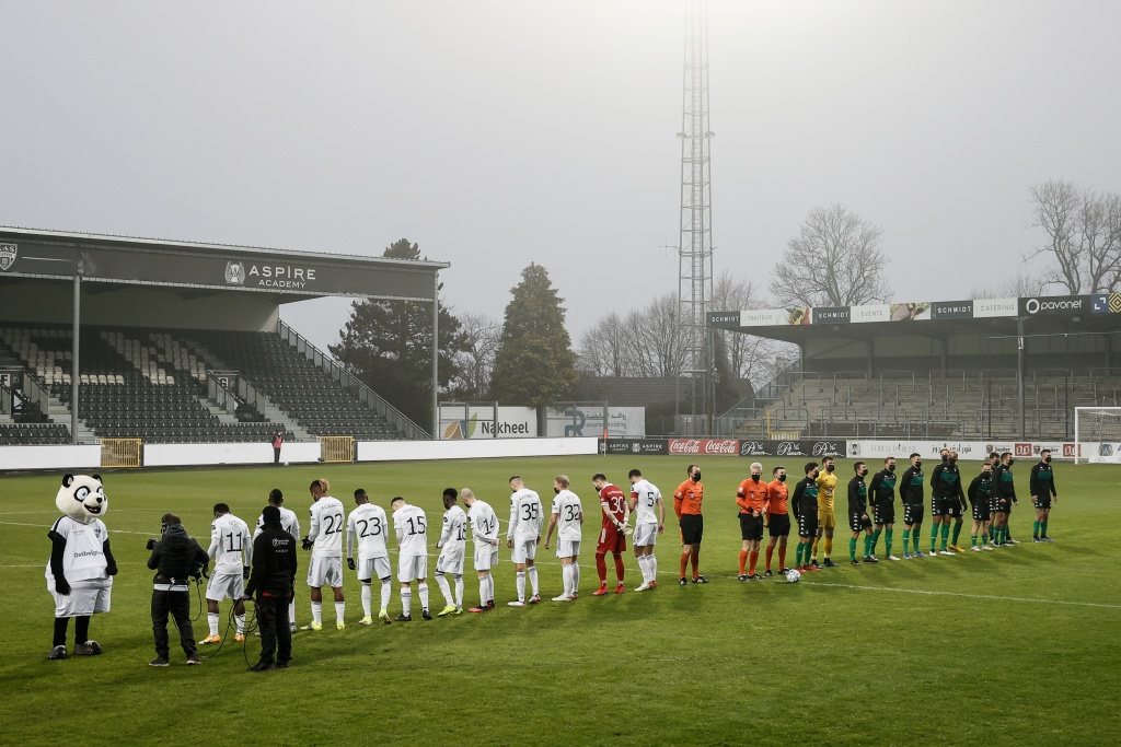 Eupen's players face away from the cameras in protest of the covid-19 protocols, before the start of a soccer match between KAS Eupen and Cercle Brugge, Sunday 16 January 2022 in Eupen, on day 22 of the 2021-2022 'Jupiler Pro League' first division of the Belgian championship. BELGA PHOTO BRUNO FAHY