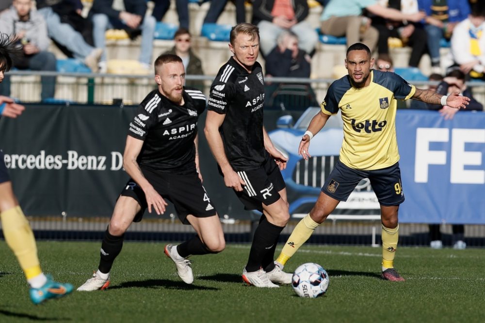 Eupen's James Jeggo, Eupen's Andreas Beck and Union's Loic Lapoussin fight for the ball during a soccer match between Royale Union Saint-Gilloise and KAS Eupen, Saturday 26 February 2022 in Brussels, on day 29 of the 2021-2022 'Jupiler Pro League' first division of the Belgian championship. BELGA PHOTO BRUNO FAHY