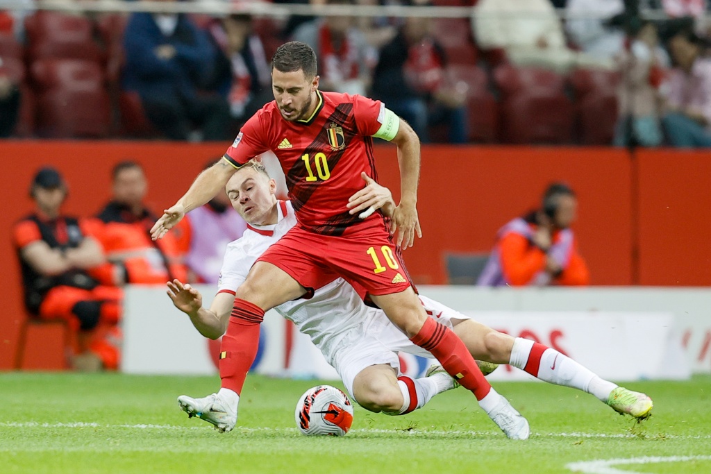Belgium's Eden Hazard and Poland's Szymon Zurkowski fight for the ball during a soccer game between Poland and Belgian national team the Red Devils, Tuesday 14 June 2022 in Warsaw, Poland, the fourth game (out of six) in the Nations League A group stage. BELGA PHOTO BRUNO FAHY
