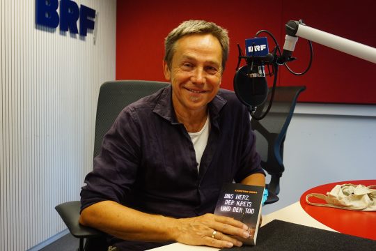 Autor Carsten Berg mit seinem neuen Krimi (Bild: Stephan Pesch/BRF)