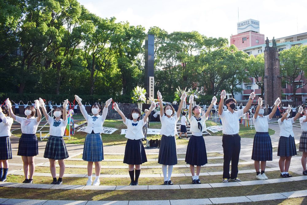 Schüler bilden eine Menschenkette um das Mahnmal in Nagasaki herum (Bild: STR/Jiji Press/AFP)