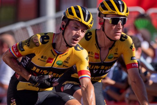 Der vom schweren Sturz sichtlich gezeichnete Primoz Roglic bei der Überquerung der Ziellinie in Tomares, an der Seite seines Teamkollegen Mike Teunissen (Bild: Jorge Guerrero/AFP)