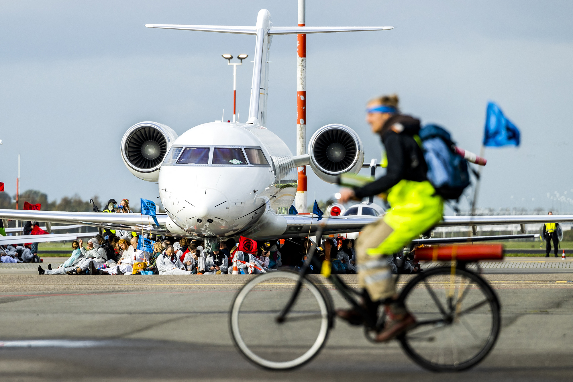 Klimaaktivisten blockieren ein Flugzeug auf dem Amsterdamer Flughafen Schiphol (Bild: Remko de Waal/ANP/AFP)