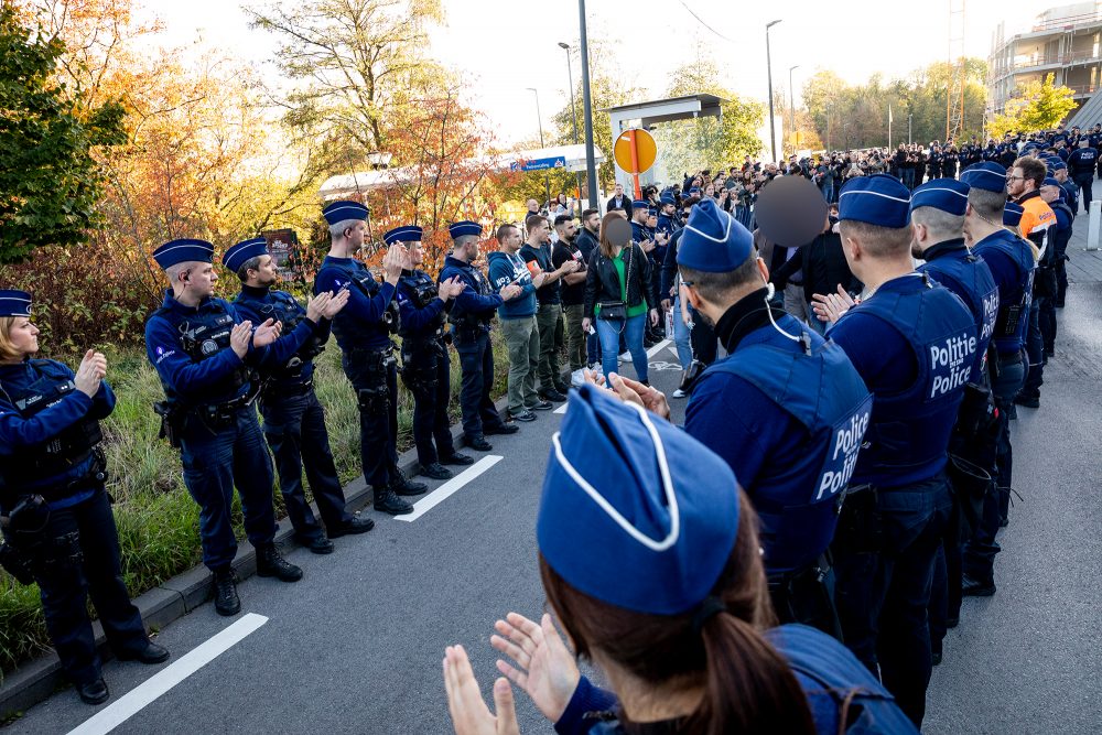 Spalier für den verletzten Polizisten, der am Samstag das Krankenhaus verlassen hat (Bild: Hatim Kaghat/Belga)