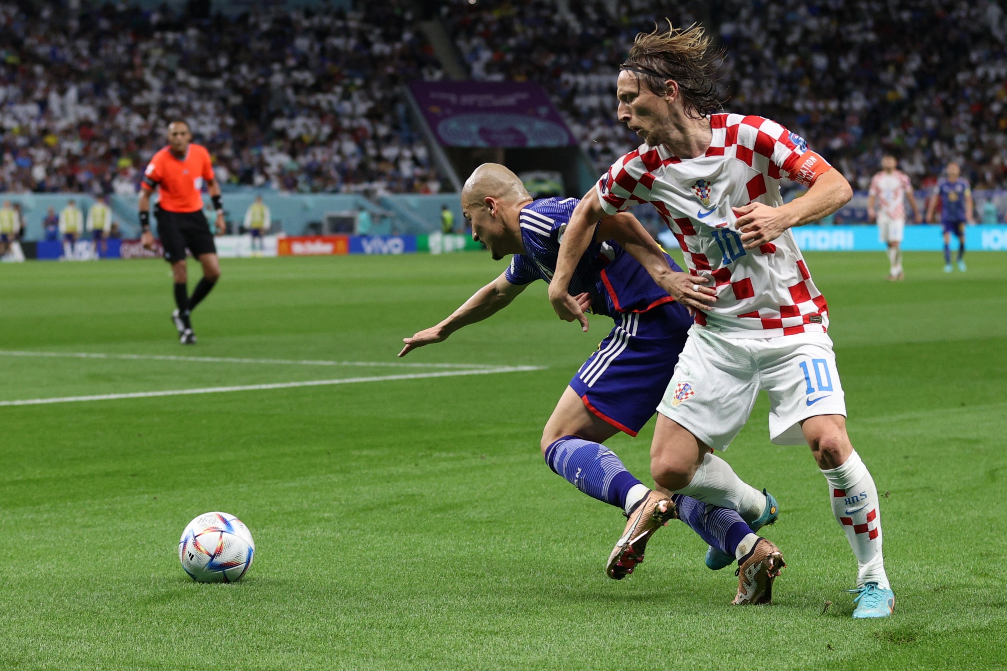 Croatia's midfielder #10 Luka Modric fights for the ball with Japan's forward #25 Daizen Maeda during the Qatar 2022 World Cup round of 16 football match between Japan and Croatia at the Al-Janoub Stadium in Al-Wakrah, south of Doha on December 5, 2022. (Photo by ADRIAN DENNIS / AFP)