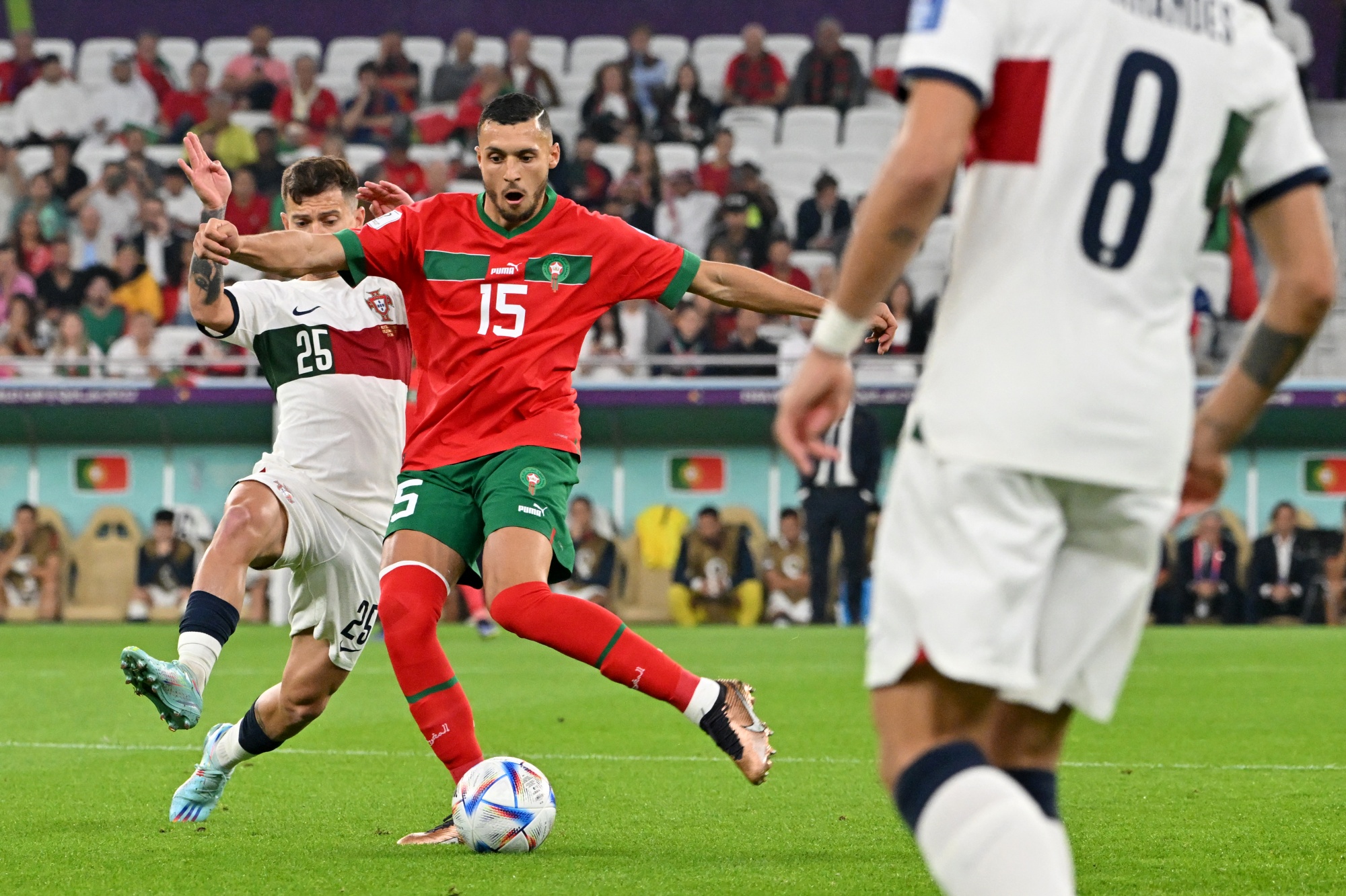 Portugal's midfielder #25 Otavio fights for the ball with Morocco's midfielder #15 Selim Amallah during the Qatar 2022 World Cup quarter-final football match between Morocco and Portugal at the Al-Thumama Stadium in Doha on December 10, 2022. (Photo by Alberto PIZZOLI / AFP)