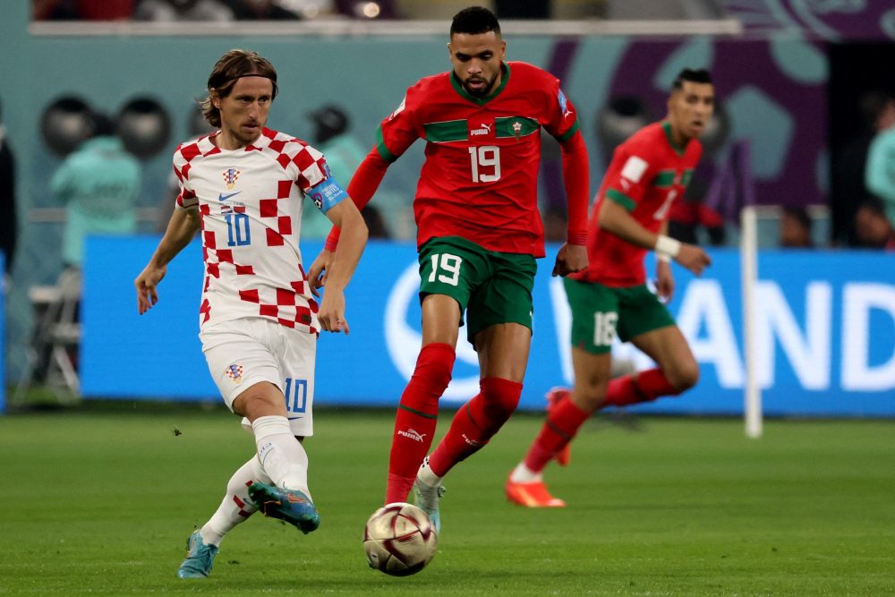 Croatia's midfielder #10 Luka Modric (L) plays the ball next to Morocco's forward #19 Youssef En-Nesyri during the Qatar 2022 World Cup third place play-off football match between Croatia and Morocco at Khalifa International Stadium in Doha on December 17, 2022. (Photo by JACK GUEZ / AFP)