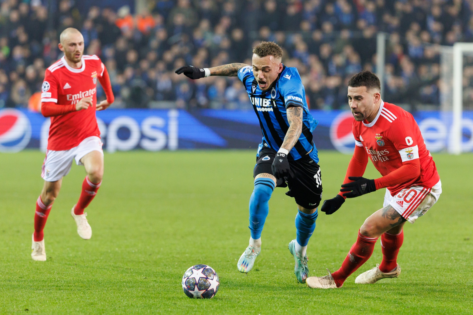 Club's Noa Lang and Benfica's Nicolas Otamendi fight for the ball during a soccer game between Belgian Club Brugge KV and Portuguese Sport Lisboa e Benfica, Wednesday 15 February 2023 in Brugge, the first leg of the round of 16 of the UEFA Champions League competition. BELGA PHOTO KURT DESPLENTER