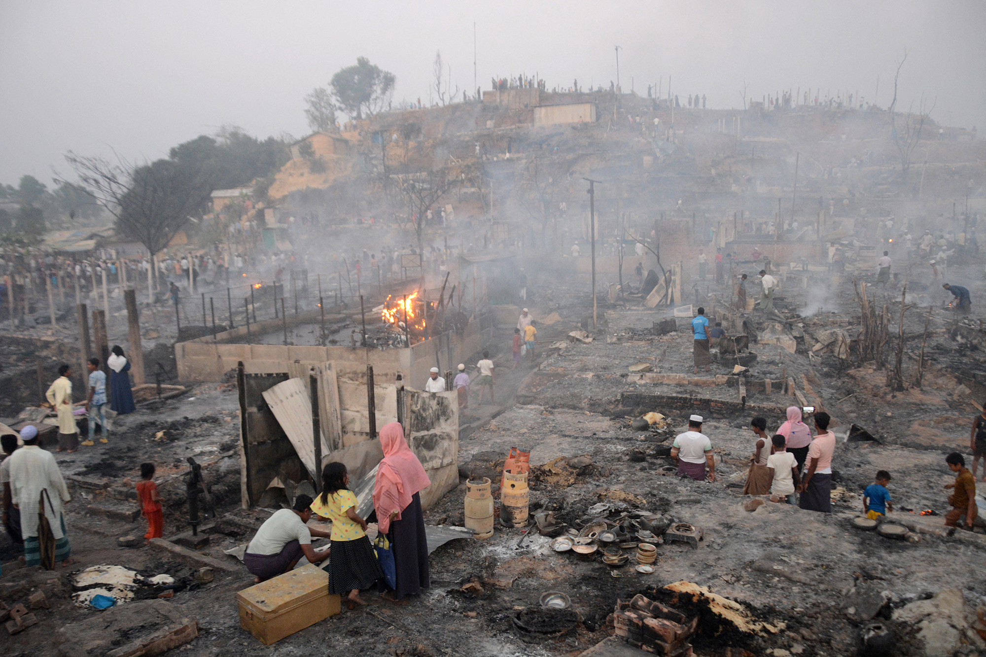 Rohingya-Flüchtlinge suchen nach dem Ausbruch eines Feuers im Flüchtlingslager Balukhali in Ukhia nach ihren Habseligkeiten (Bild: Tanbir Miraz/AFP)