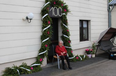 Petronella Braun aus Medell feiert 100. Geburtstag - der JGV gratuliert mit einem Türkranz (Bild: Katrin Margraff/BRF)