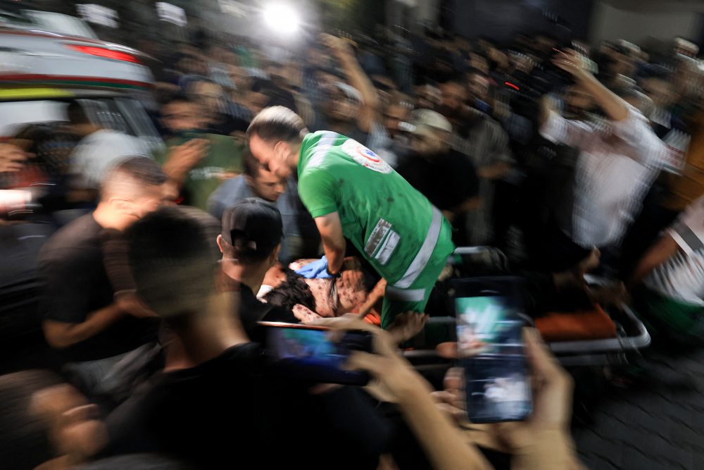 Ein palästinensischer Sanitäter hilft einem Verwundeten nach einer Explosion in der Nähe des Grenzzauns zu Israel in Gaza-Stadt (Bild: Mahmud Hams/AFP)