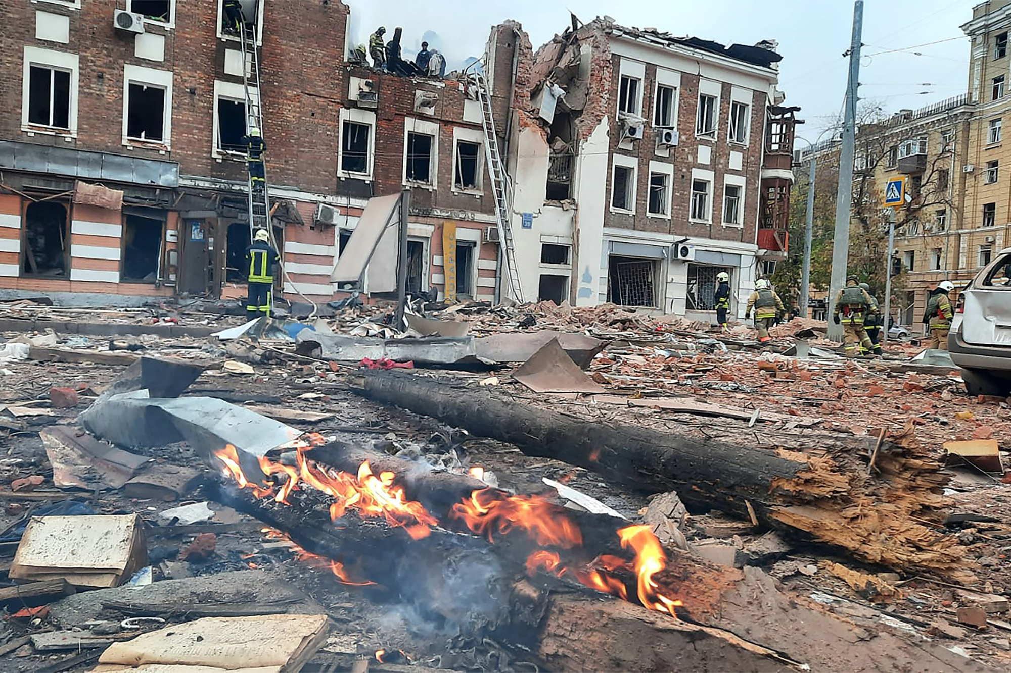 Feuerwehrleute bei den Löscharbeiten nach einem russischen Angriff auf das Zentrum der ukrainischen Stadt Charkiw (Bild: Handout/Ukrainian Emergency Service/AFP)