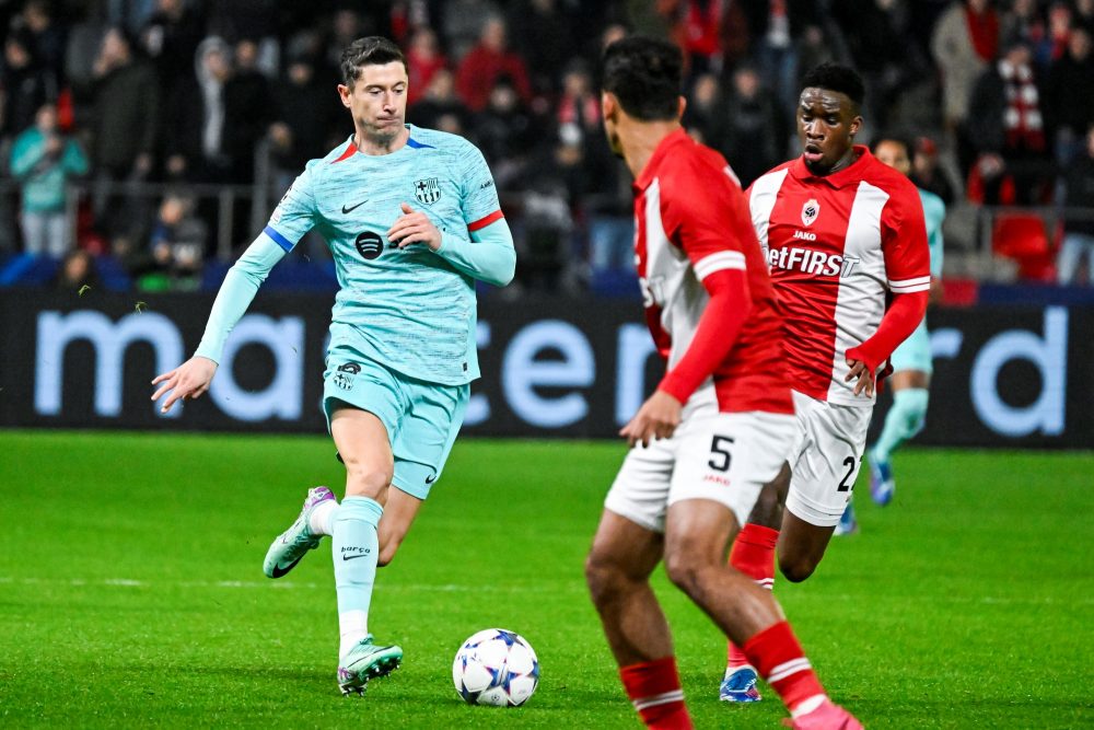 Barcelona's Robert Lewandowski and Antwerp's Mandela Keita pictured in action during a game between Belgian soccer team Royal Antwerp FC and Spanish club FC Barcelona, in Antwerp, on Wednesday 13 December 2023, day six of the Champions League group stage, in group H. BELGA PHOTO TOM GOYVAERTS