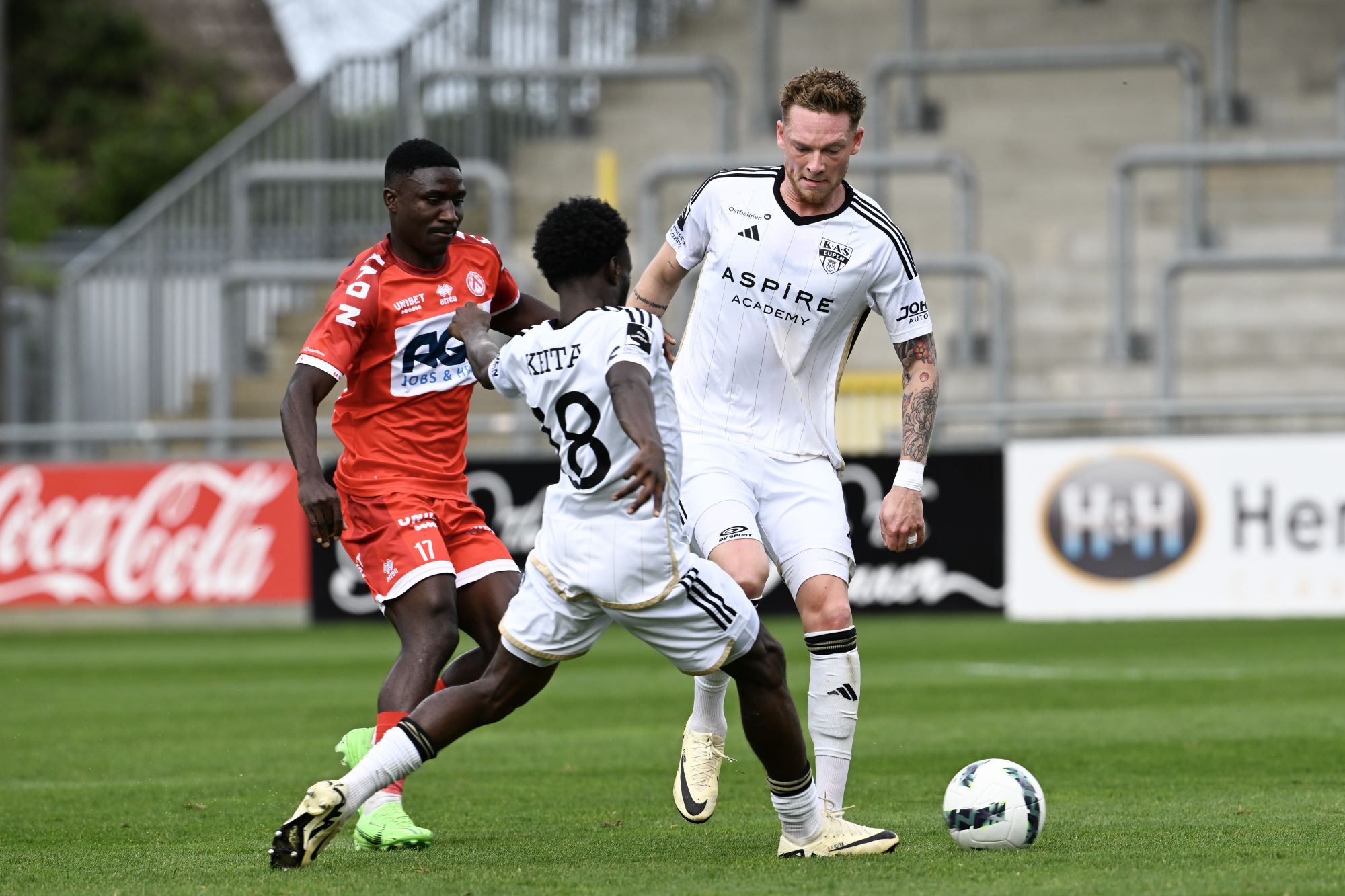 Kortrijk's Kings Kangwa and Eupen's Renaud Emond fight for the ball during a soccer match between KAS Eupen and KV Kortrijk, Sunday 07 April 2024 in Eupen, on the first day of the 2023-2024 'Jupiler Pro League - Relegation Play-offs. BELGA PHOTO JOHN THYS