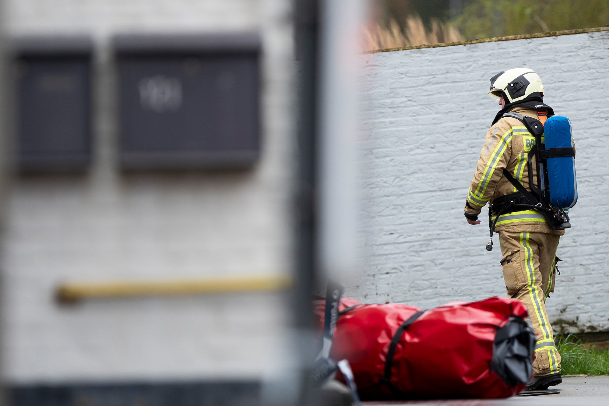 Feuerwehrmann vor dem Gebäude in Poederlee, in dem die Toten entdeckt wurden (Bild: Kristof Van Accom/Belga)