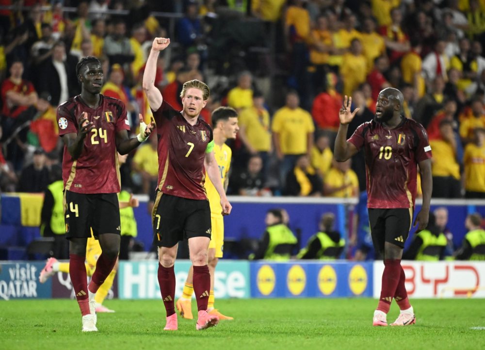 Belgium's captain Kevin De Bruyne celebrates after scoring the 2-0 with team-mates Belgium's Amadou Onana and Belgium's Romelu Lukaku at a soccer game between Belgian national soccer team Red Devils and Romania, Saturday 22 June 2024 in Cologne, Germany, the second match in the group stage of the UEFA Euro 2024 European championships. BELGA PHOTO DIRK WAEM