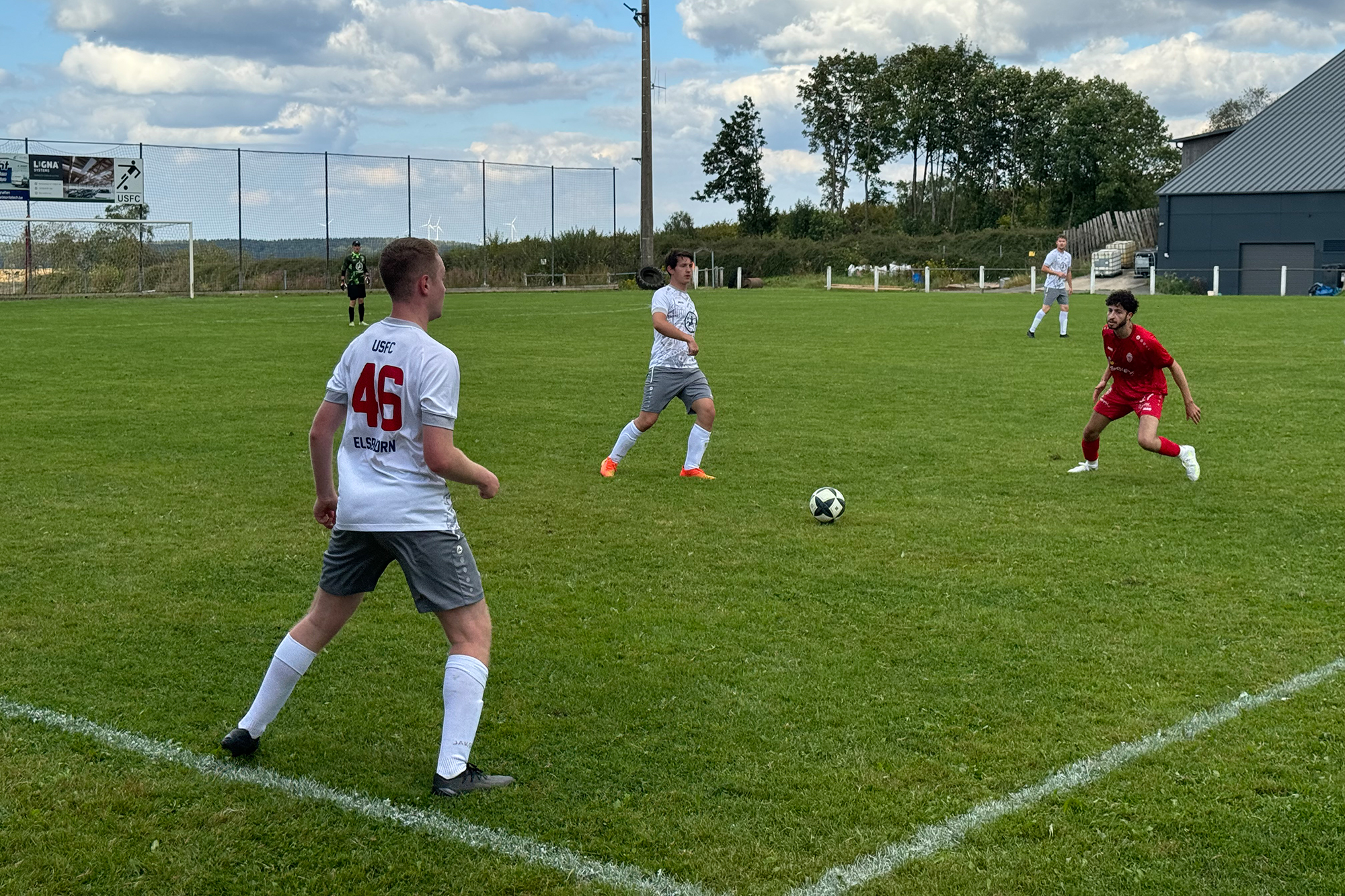 Spieler des KFC Lontzen und des USFC Elsenborn kämpfen auf dem Spielfeld um den Ball