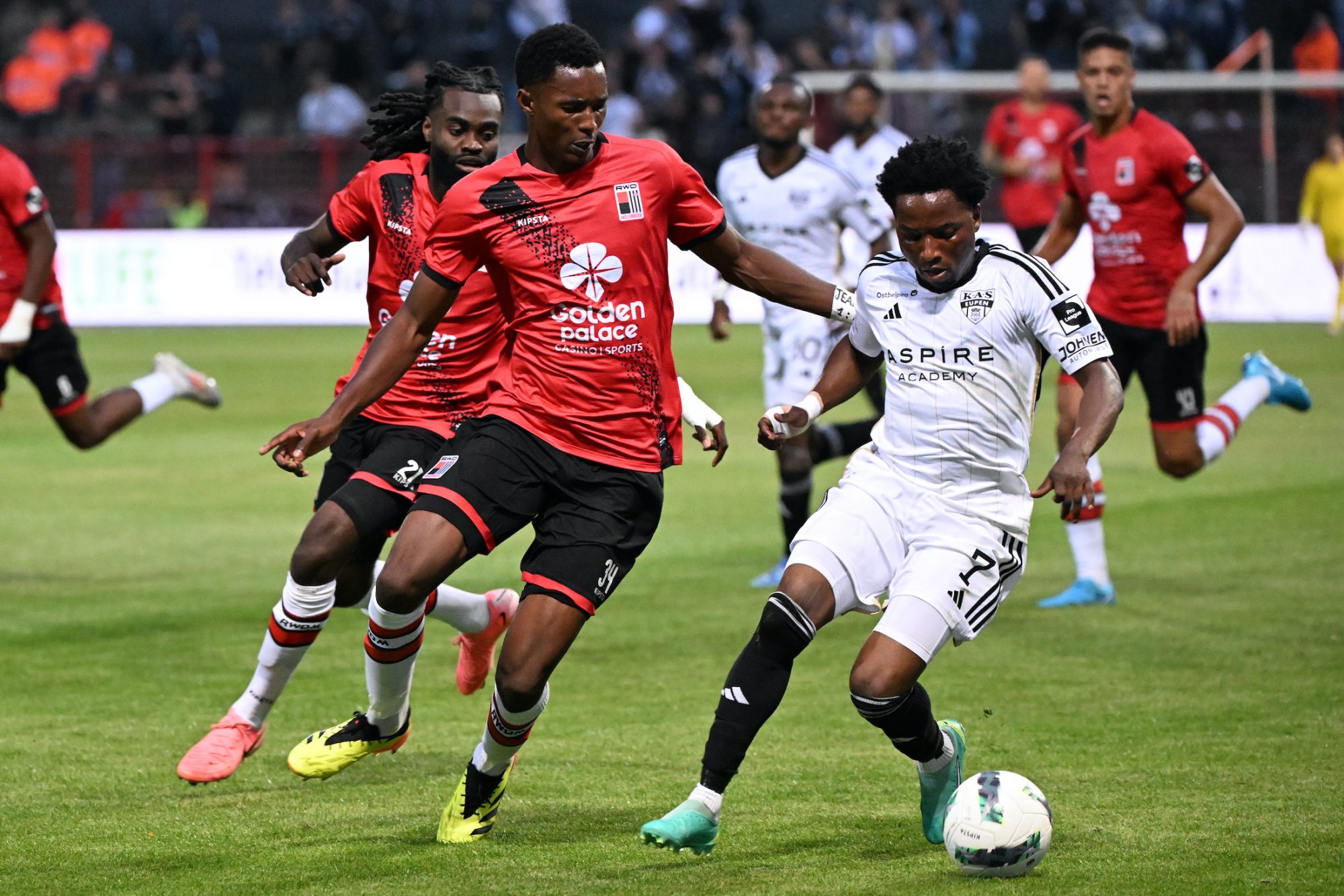 Rwdm's Christ Makosso and Eupen's Isaac Nuhu fight for the ball during a soccer match between RWD Molenbeek and KAS Eupen, Friday 30 August 2024 in Brussels, on day 3 of the 2024-2025 'Challenger Pro League' 1B second division of the Belgian championship. BELGA PHOTO LAURIE DIEFFEMBACQ