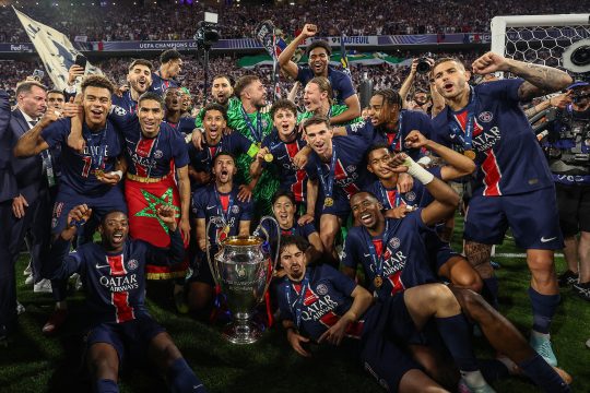 Spieler von PSG posieren für ein Mannschafts-Jubel-Foto mit dem Champions-League-Pokal
