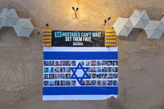 Große israelische Flagge mit den Porträts der Geiseln