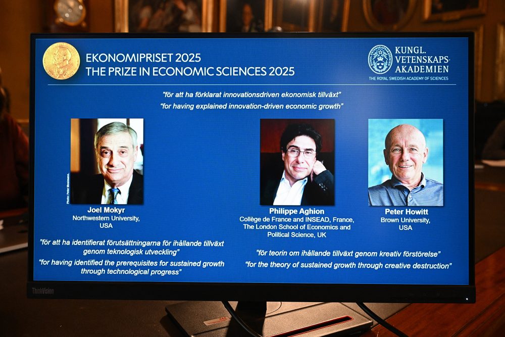 Bilder der drei Preisträger Joel Mokyr sowie Philippe Aghion und Peter Howitt auf der Anzeigentafel bei der Bekanntgabe der Wirtschaftsnobelpreisträger