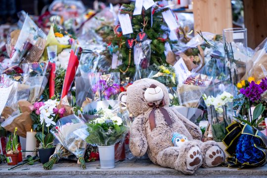 Blumen und Teddybär zum Gedenken der Opfer von Crans-Montana