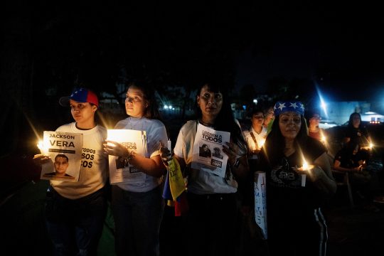 Angehörige politischer Gefangener zünden während einer Mahnwache Kerzen an