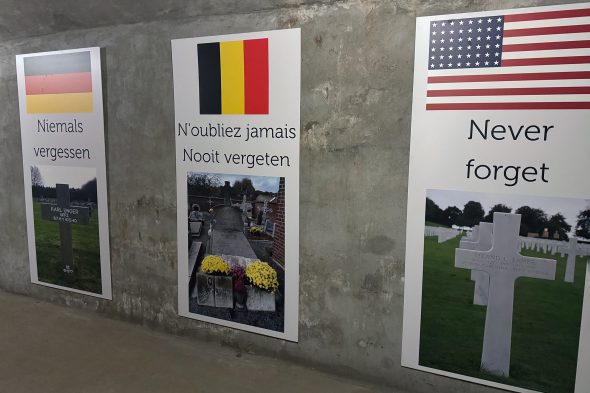Schilder 'niemals vergessen' auf mehreren Sprachen in der neuen immersiven Ausstellung im Fort Eben-Emael